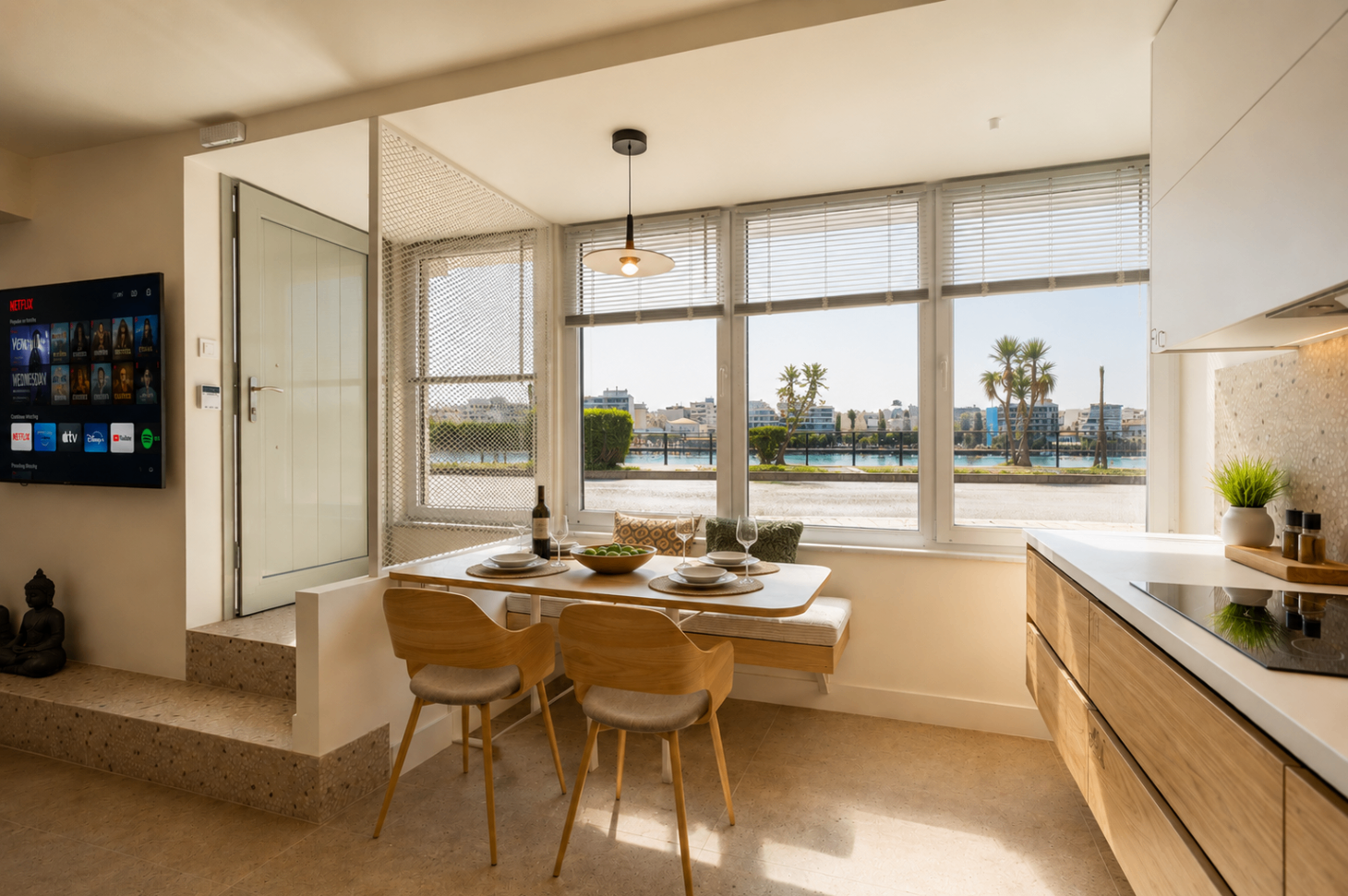 Niriis Suite 3 dining table by the window with waterfront view
