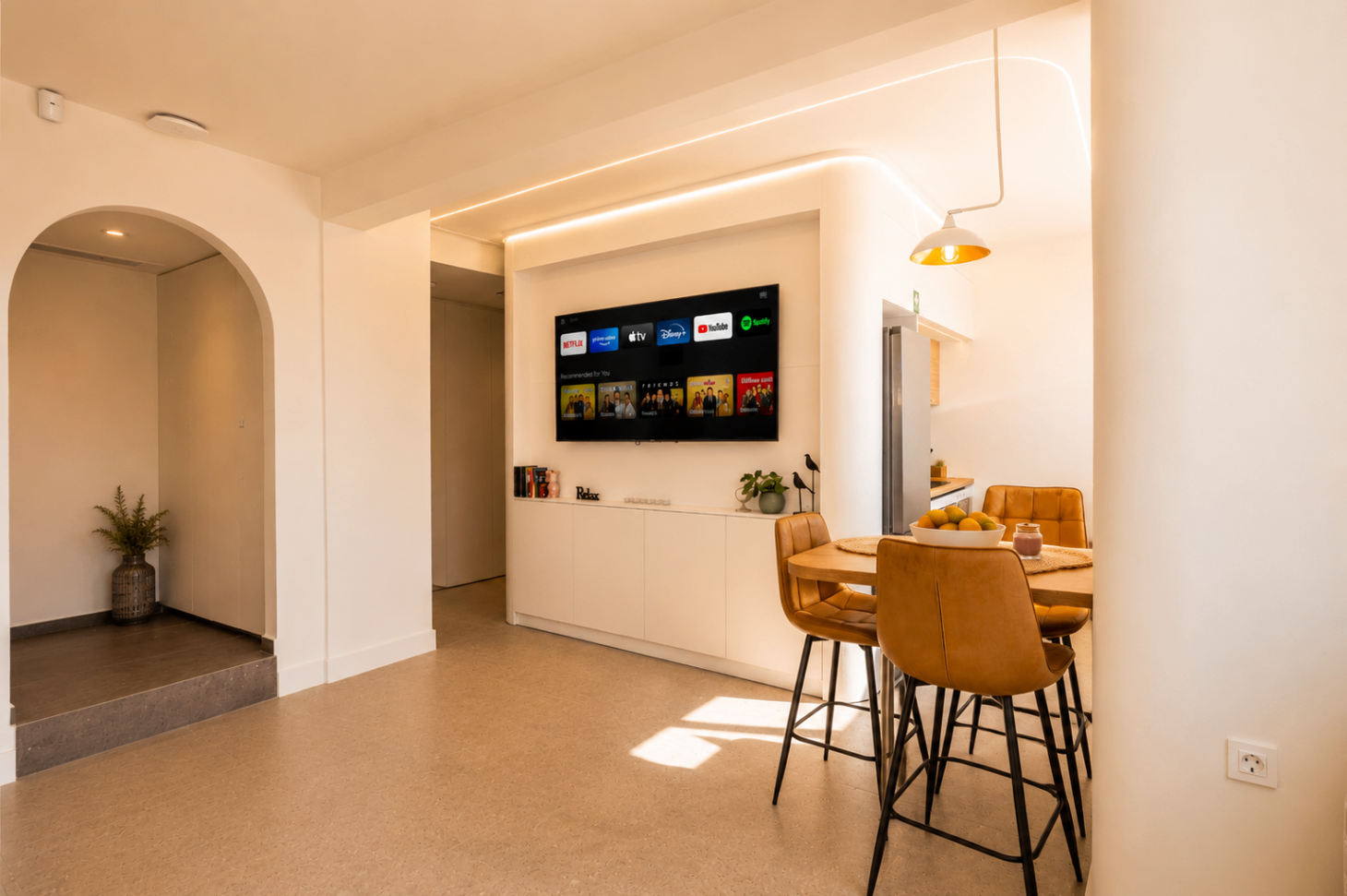 Niriis Suite 1 living and dining area with ambient ceiling lighting and TV wall