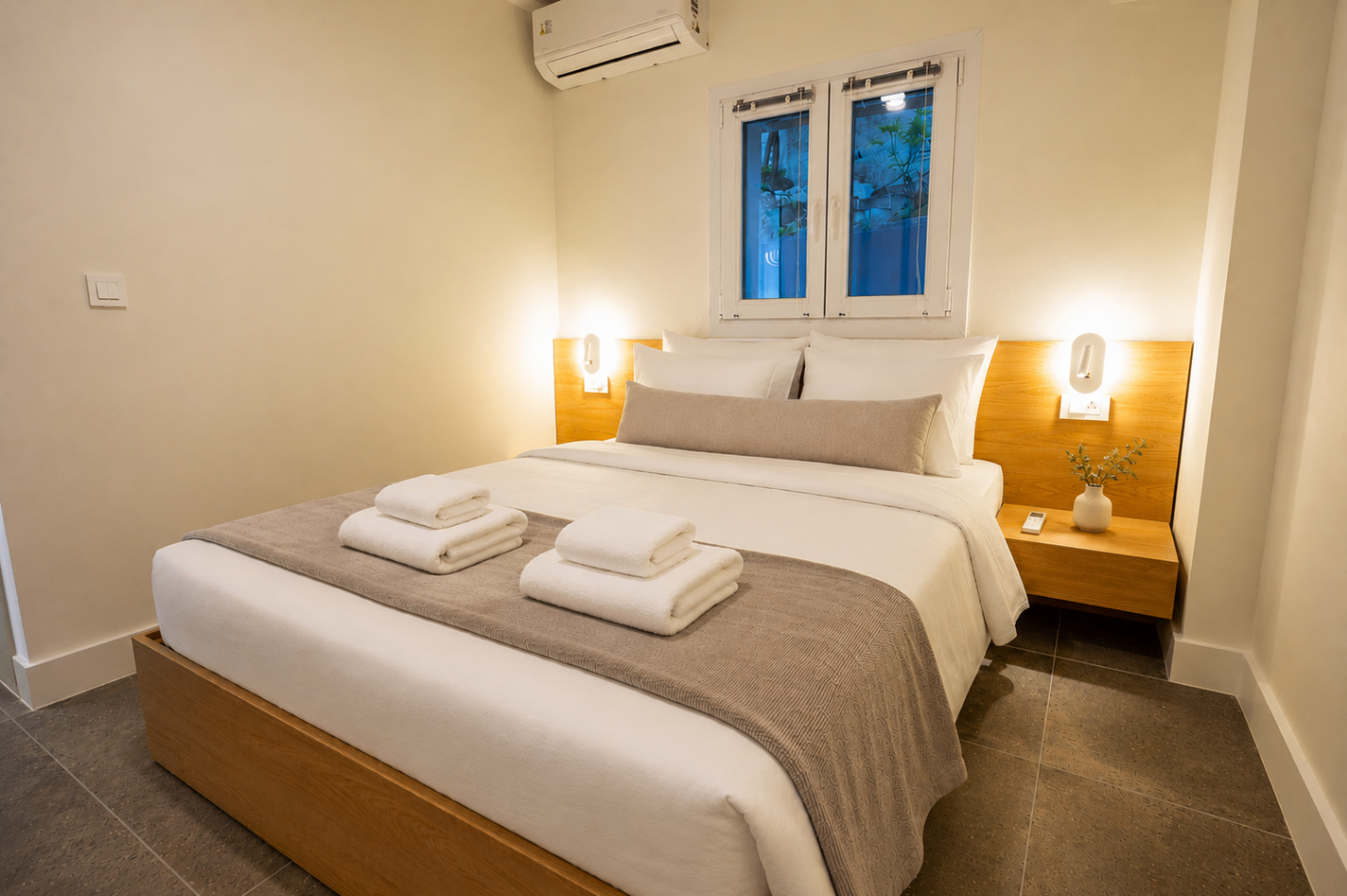 Niriis Suite 2 bedroom with king bed and warm bedside lighting