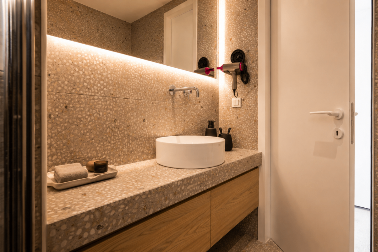 Niriis Suite 1 bathroom vanity with stone surfaces and illuminated mirror